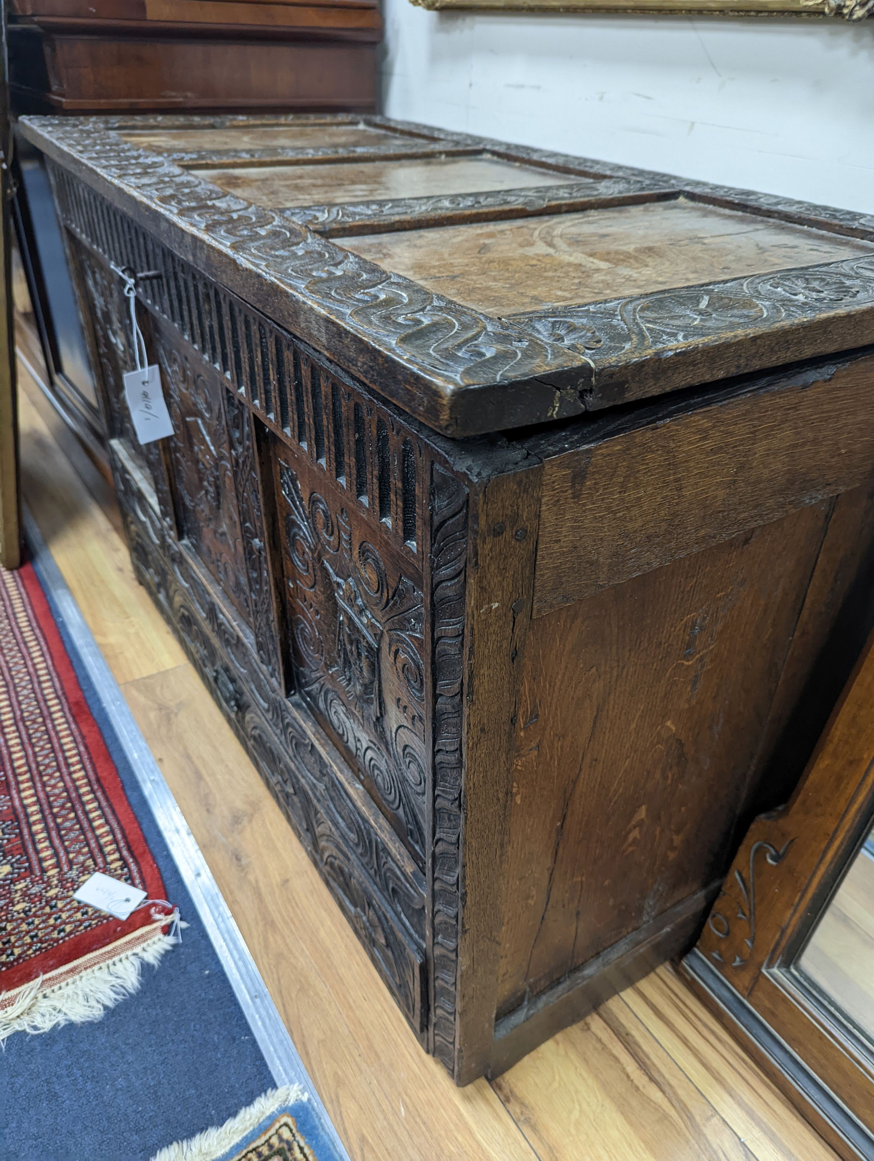 An 18th century oak mule chest with later carved decoration, length 103cm, depth 53cm, height 66cm